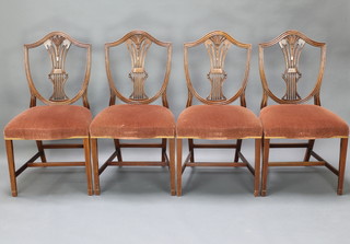 A set of 4 Hepplewhite style shield back dining chairs with over stuffed seats, raised on square tapered supports with H framed stretcher