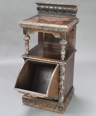 A Victorian carved oak coal purdonium with raised back and recess, raised on a platform base 39"h x 18 1/2"w x 15"d 