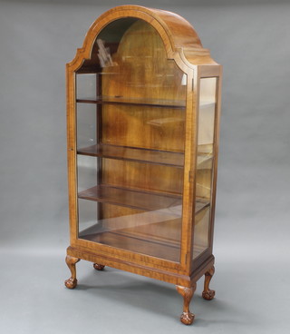 An Art Deco Georgian style arched walnut display cabinet, fitted adjustable shelves and raised on carved cabriole ball and claw supports 69"h x 33"w x 14"d 
