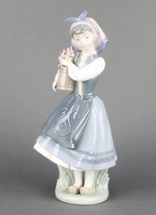 A Lladro group of a girl holding a bucket of flowers 1416 10 1/2" 