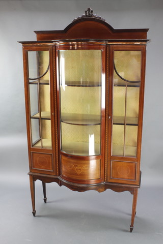 An Edwardian inlaid mahogany bow front display cabinet with raised back, fitted shelves enclosed by a bow front panel flanked by a pair of cupboards, raised on square tapered supports, spade feet 82"h x 44 1/2"w x 15"d 