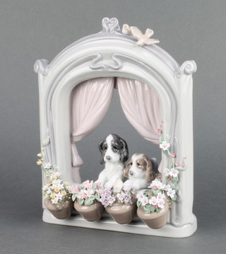 A Lladro group of 2 dogs at a window looking at a bird amongst flower pots of flowers 9" 