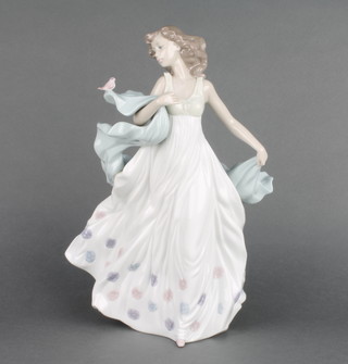 A Lladro figure of a girl with shawl and bird 6193 12 1/2" 