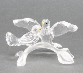 A Swarovski Crystal group of 2 birds on a branch 4" boxed