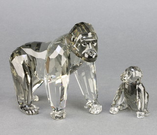 A Swarovski Crystal figure of a walking gorilla 5" and a do. baby gorilla 2" boxed