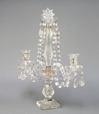 A 19th Century cut glass 2 light candelabrum with faceted lustres and swags on a square base 19" 