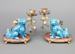 A pair of 19th Century Chinese turquoise glazed figures of Shi Shi on raised gilt bases with floral single light candle holders 6" 