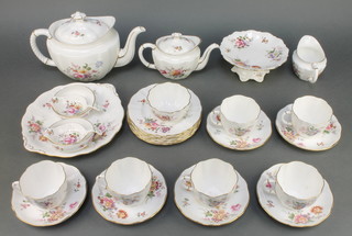 A Royal Crown Derby Derby Posies part tea set comprising teapot and lid, cream jug, breakfast teapot and lid, tea strainer and stand, 7 tea cups, 6 saucers, 6 small plates, 1 serving plate, a tazza, a boxed tea strainer and stand 