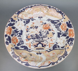 A large 20th Century Imari charger decorated with a vase of flowers enclosed in a floral border with exotic birds 24" 