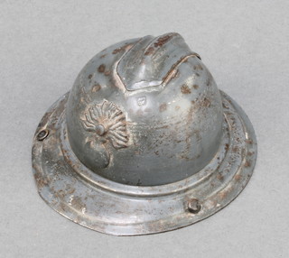 A painted metal inkwell in the form of a French Adrien helmet complete with glass liner (slight chip to top) 2" x 3"diam. 