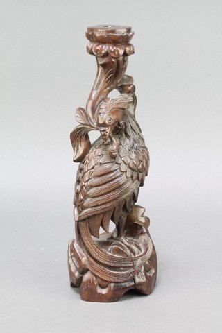 A carved hardwood figure of a fabulous bird with hardstone set eyes 12 1/2"h x 4" diam. 