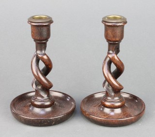 A pair of 1920's spiral turned oak candlesticks with detachable metal sconces 6" 