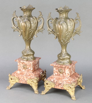 A pair of French Art Nouveau spelter twin handled urns raised on polished granite bases 17" x 8" 