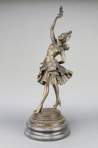 A reproduction bronze figure of a female dancing harlequin raised on a turned marble base 22" 