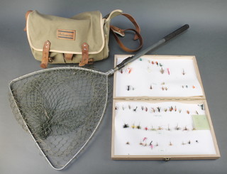A Shakespeare canvas and leather fishing bag containing 3 fly boxes with flies, a wooden fly box and contents and a Sharpe's landing net 