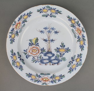 An 18th Century English Delft polychrome plate decorated with stylised flowers on a pale blue ground 13 1/2" 