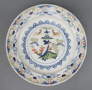 An 18th Century English Delft polychrome plate decorated with stylised chickens amongst trees within a floral border 13" 