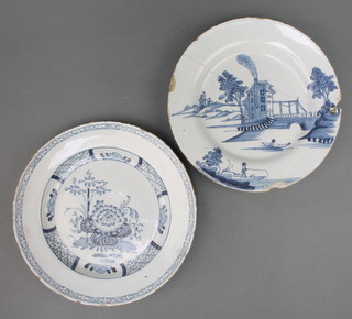 An 18th Century English Delft blue and white plate decorated with flowers in a geometric border 9", a do. decorated with a fisherman, figure in a boat and buildings 9" 
