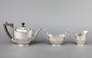An Edwardian silver 3 piece bachelors tea set with demi fluted and ebony mounts, Sheffield 1900 gross 408 grams 
