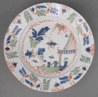 An 18th Century English Delft polychrome dish decorated with a pavilion enclosed in a geometric border 13" 