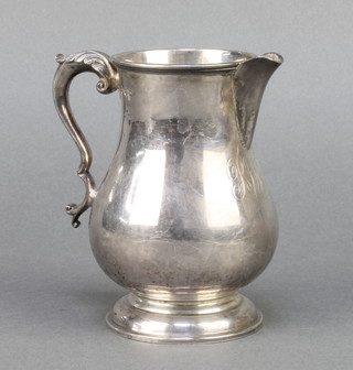A silver pedestal cream jug with fancy handle and chased monogram Sheffield 1915 237 grams 