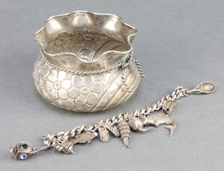 A silver charm bracelet and an 800 standard repousse bowl 247 grams 