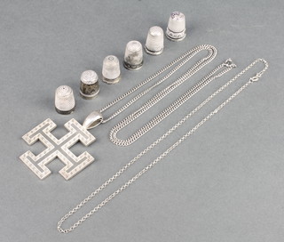 A silver cross pendant and 6 silver thimbles, 78 grams 