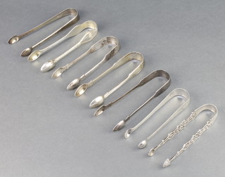 A pair of Georgian silver fancy sugar nips with pierced decoration in shell bowls, 6 other pairs of sugar nips 318 grams 