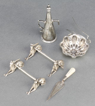 A pair of Edwardian silver plated novelty knife rests in the form of reclining greyhounds with crops, a snuffer, a tea strainer and a bookmark