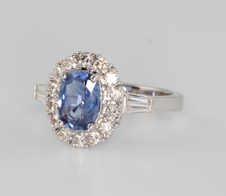 An 18ct white gold sapphire and diamond cluster ring, the centre stone approx. 1.47ct surrounded by brilliant and tapered baguette cut diamonds approx. 0.75ct size N 