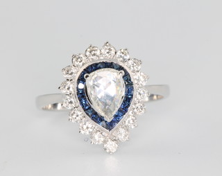 An 18ct white gold pear shaped diamond and sapphire ring, the centre stone approx 0.4ct surrounded by sapphires approx. 0.88ct surrounded by brilliant cut diamonds approx. 0.64ct, size N 1/2