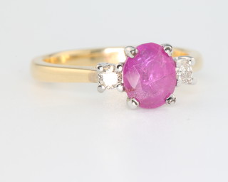 An 18ct yellow gold ruby and diamond ring, the centre stone approx. 1.35ct flanked by brilliant cut diamonds approx. 0.15ct, size M  
