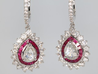 A pair of 18ct white gold pear shaped diamond and ruby ear clips, the rubies approx 1.55ct, the pear cut diamonds approx. 0.68ct surrounded by brilliant cut diamonds approx. 1.48ct