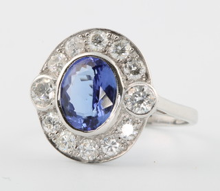 An 18ct white gold oval tanzanite and diamond ring, the centre stone approx. 1.35ct surrounded by brilliant cut diamonds approx. 2.5ct size P 