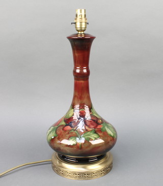 A Moorcroft red ground and clematis pattern oviform table lamp with waisted neck and gilt metal mounts 14"  