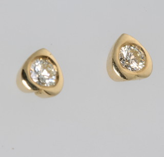 A pair of 18ct yellow gold heart shaped earrings set with brilliant cut diamonds 