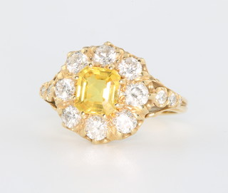 An 18ct yellow gold Victorian style yellow sapphire and diamond ring, the centre stone approx. 1.3ct surrounded by 14 diamonds approx. 1.4ct, size N 1/2