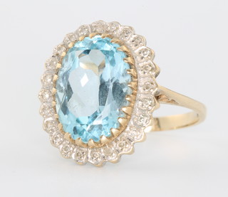 A 9ct yellow gold aquamarine and diamond cluster ring size O 