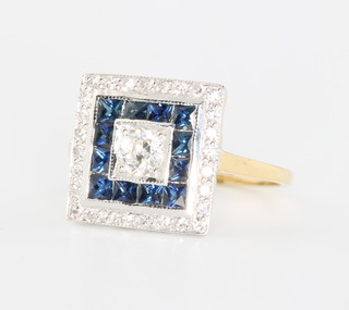 An 18ct yellow gold Art Deco style ring the centre diamond surrounded by 12 princess cut sapphires surrounded by brilliant cut diamonds, size N 