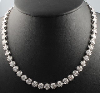 A good 18ct white gold diamond set necklace comprising 37 brilliant cut diamonds, approx. 19.92ct in claw settings, gross weight 40 grams, 17" long