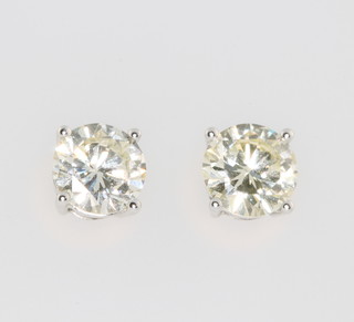 A pair of 18ct white gold single stone diamond ear studs, 1.34ct and 1.35ct 