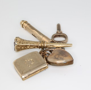 Three gilt watch keys, a heart pendant and charm 