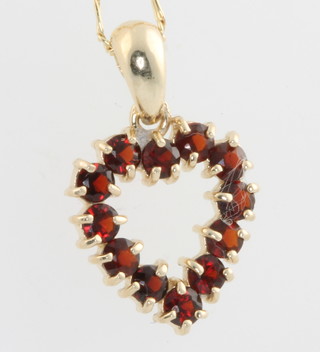 A yellow gold chain with ditto garnet set heart shaped pendant 