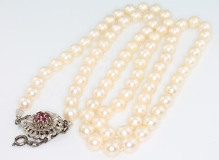 An Akoya pearl necklace with 18ct white gold ruby set clasp 28" 