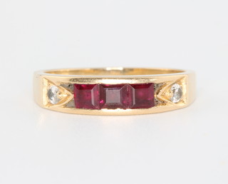 An 18ct yellow gold ruby and diamond ring with 3 princess cut rubies and 2 brilliant cut diamonds, size O 1/2