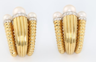 A fine pair of 1970's 18ct yellow gold ribbed ear clips with cultured pearl terminals each surrounded by 21 brilliant cut diamonds, gross weight 38 grams, 33mm x 23mm 