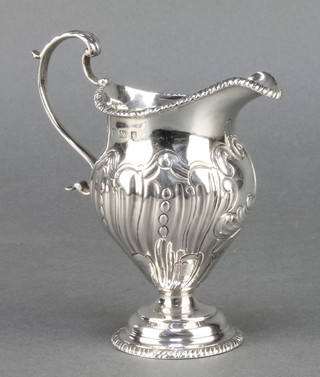 A repousse silver cream jug with S scroll handle Birmingham 1927 4 1/2" 