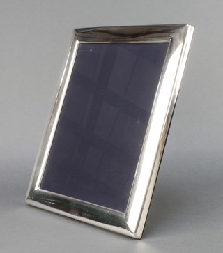 A modern silver photograph frame of plain design 12" x 10" 