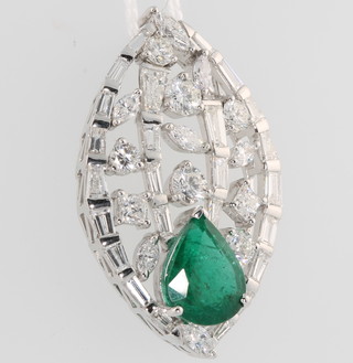 A 14ct white gold elliptical pendant set with a pear cut emerald approx 5.1ct surrounded by brilliant baguette and tapered baguette diamonds approx. 6.15ct 43mm x 27mm 