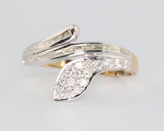 A 9ct yellow gold diamond set serpent ring, set with brilliant and baguette cut diamonds, size R 1/2